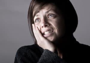 woman holding her jaw in pain due to a toothache