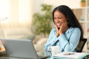 Black self employed woman suffering tmj at home