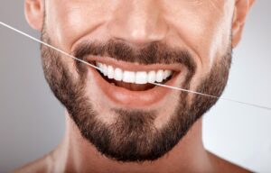 Dentist,,Floss,And,Mouth,Of,Man,With,Smile,On,Gray