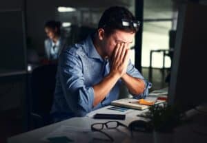 Man at his desk looking stressed leading to jaw pain in McLean, VA