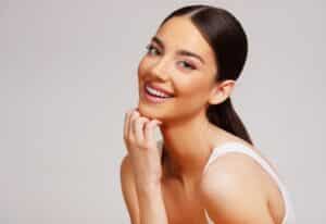 Woman smiling with straight, flawless teeth from porcelain veneers in McLean, VA